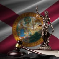Florida,Us,State,Flag,With,Statue,Of,Lady,Justice,,Constitution